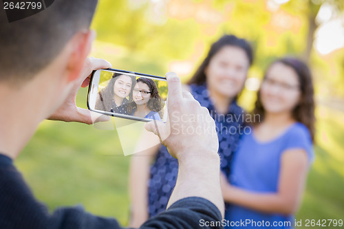 Image of Man Takes Cell Phone Picture of Wife and Daughter