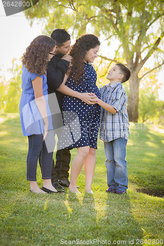 Image of Happy Attractive Hispanic Family With Their Pregnant Mother Outd