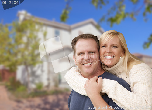 Image of Happy Couple Hugging In Front of House