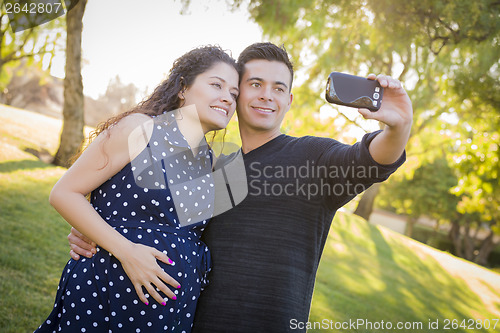 Image of Pregnant Wife and Husband Taking Cell Phone Picture of Themselve
