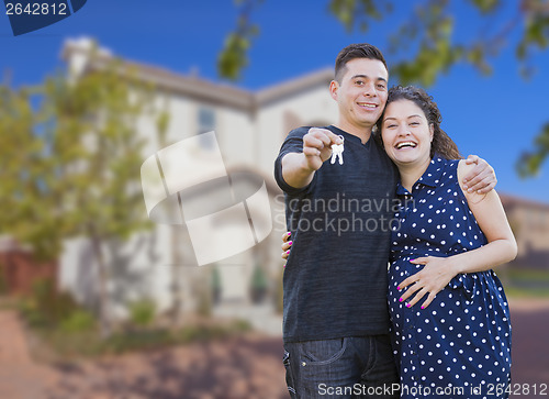 Image of Hispanic Couple with House Keys In Front of New Home