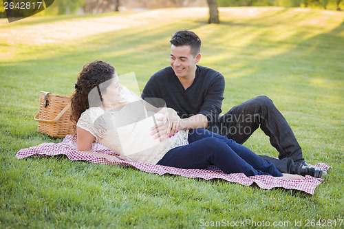 Image of Pregnant Hispanic Couple in The Park Outdoors