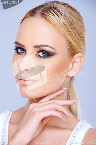 Image of Beautiful blue-eyed woman wearing makeup