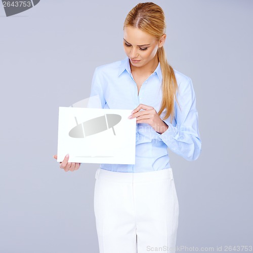 Image of Beautiful elegant blond holding a blank white sign