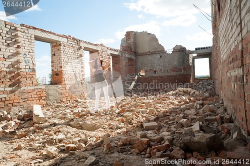 Image of Grunge portrait of a woman in urban ruins
