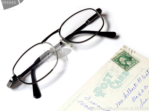 Image of Old postcard and eyeglasses