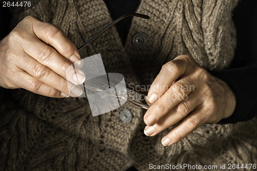 Image of Women hands hold glasses