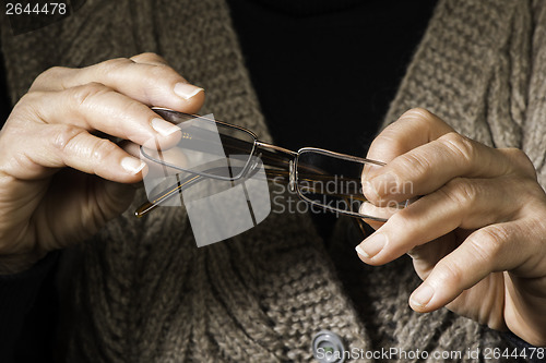 Image of Women hands hold glasses