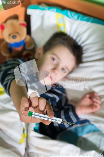 Image of Sick child in bed with teddy bear