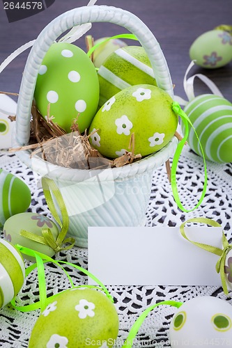 Image of Colourful green Easter eggs in straw