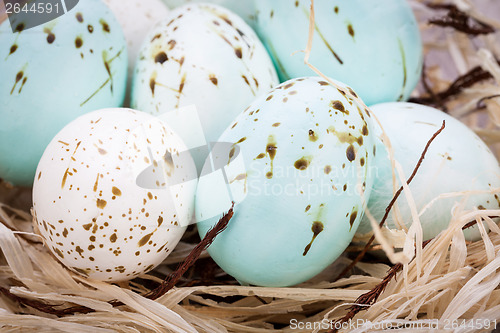 Image of Three natural blue Easter eggs in a basket