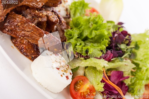 Image of grilled beef stripes fresh salad and goat cheese