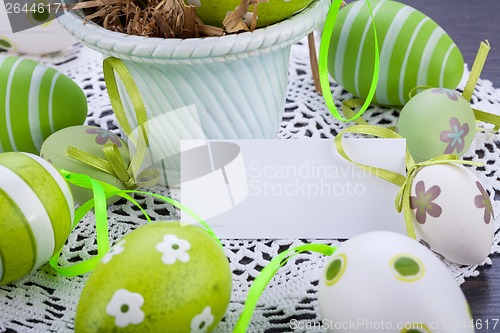 Image of Colourful green Easter eggs in straw