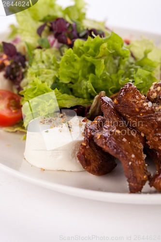 Image of grilled beef stripes fresh salad and goat cheese