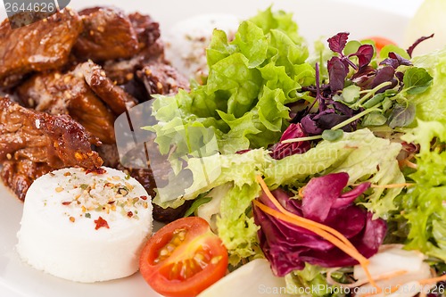 Image of grilled beef stripes fresh salad and goat cheese