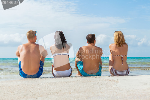 Image of young happy friends havin fun on the beach