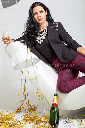 Image of Seductive brunette holding a glass of champagne