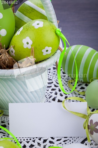 Image of Colourful green Easter eggs in straw