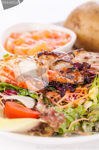 Image of Grilled prawns with endive salad and jacket potato