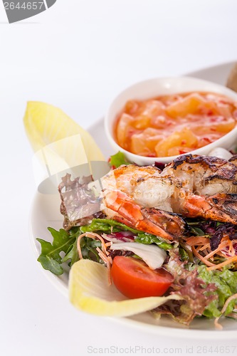 Image of Grilled prawns with endive salad and jacket potato