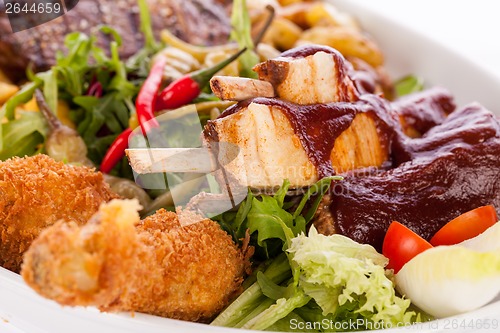 Image of Platter of mixed meats, salad and French fries