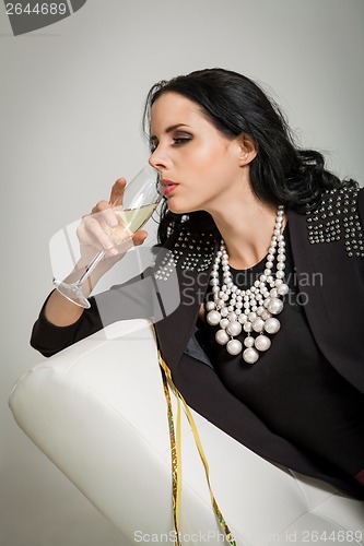 Image of Seductive brunette holding a glass of champagne