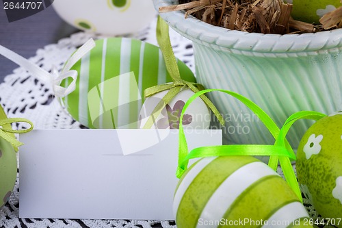 Image of Colourful green Easter eggs in straw