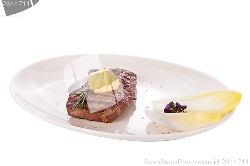 Image of Grilled beef steak topped with butter and rosemary