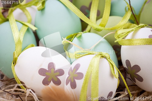 Image of Colourful green Easter eggs in straw