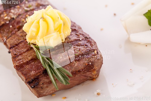 Image of Grilled beef steak topped with butter and rosemary