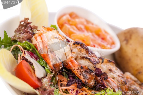 Image of Grilled prawns with endive salad and jacket potato