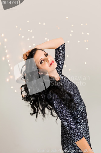 Image of Beautiful dreamy woman with glitter dress dancing