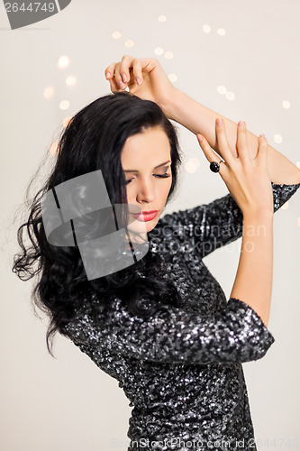 Image of Beautiful dreamy woman with glitter dress dancing