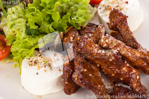 Image of grilled beef stripes fresh salad and goat cheese