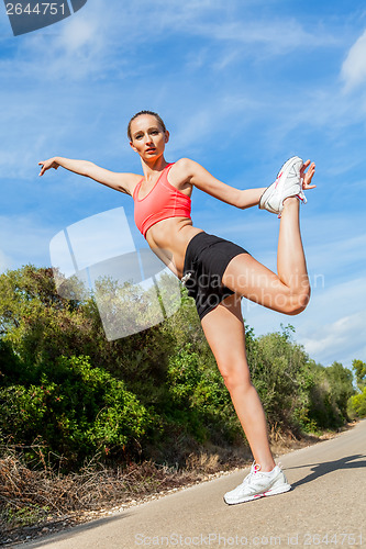 Image of young attractive athletic woman stretching fitness