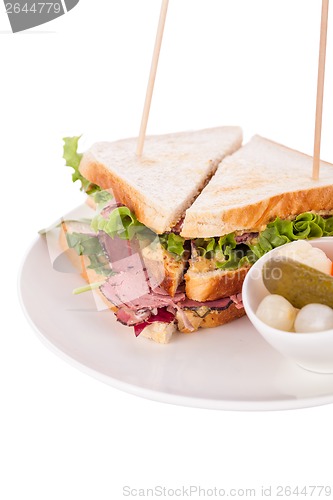 Image of Delicious pastrami club sandwich and pickles