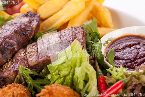 Image of Platter of mixed meats, salad and French fries