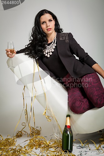 Image of Seductive brunette holding a glass of champagne