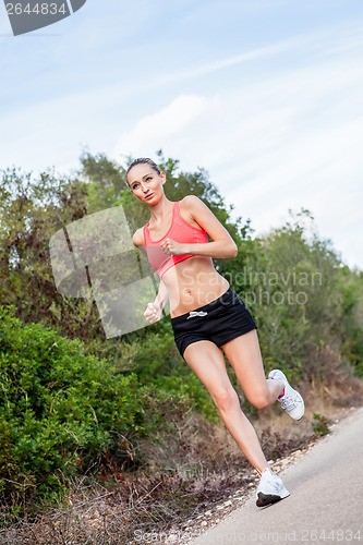 Image of young athletic woman runner jogger outdoor