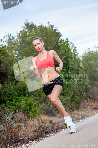 Image of young athletic woman runner jogger outdoor