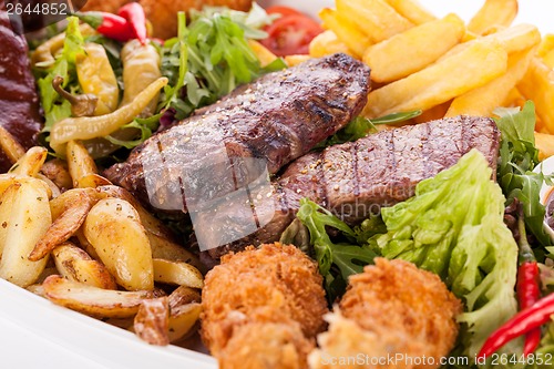 Image of Platter of mixed meats, salad and French fries