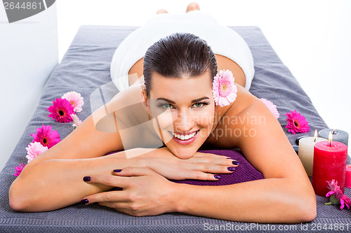 Image of Beautiful woman enjoying a hot stone massage