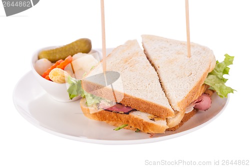 Image of Delicious pastrami club sandwich and pickles