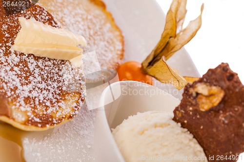 Image of tasty sweet pancakes with vanilla icecream and topping