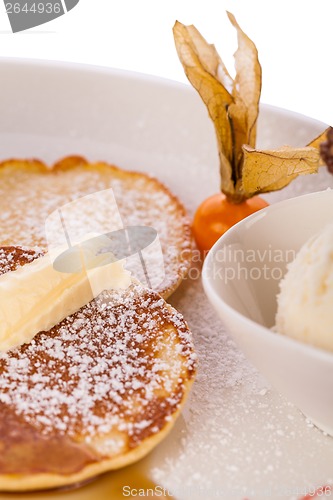 Image of tasty sweet pancakes with vanilla icecream and topping