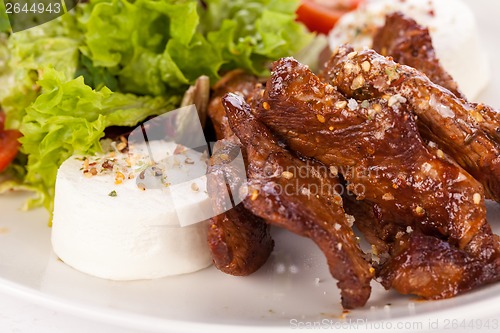 Image of grilled beef stripes fresh salad and goat cheese