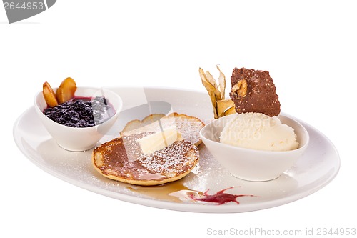 Image of tasty sweet pancakes with vanilla icecream and topping