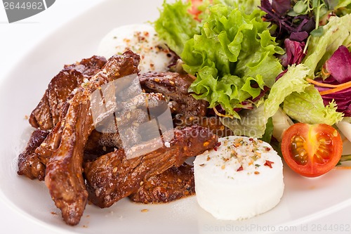 Image of grilled beef stripes fresh salad and goat cheese