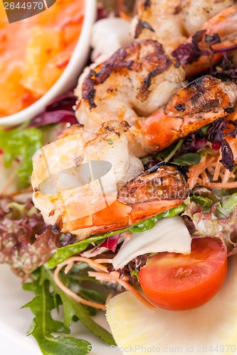 Image of Grilled prawns with endive salad and jacket potato