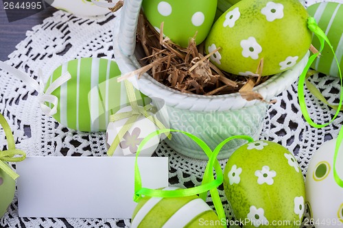 Image of Colourful green Easter eggs in straw